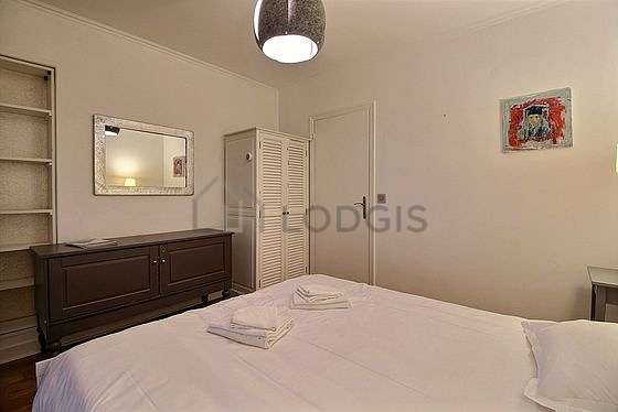 Bright bedroom equipped with wardrobe, bedside table