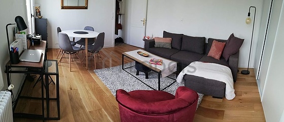 Very quiet living room furnished with tv, fan, 1 armchair(s), 1 chair(s)