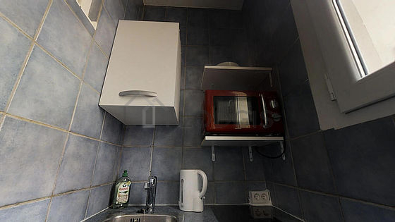 Kitchen equipped with hob, refrigerator, freezer, crockery