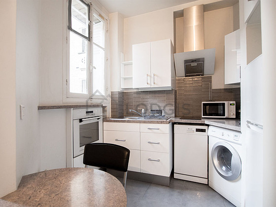 Kitchen where you can have dinner for 2 person(s) equipped with washing machine, refrigerator, extractor hood, crockery