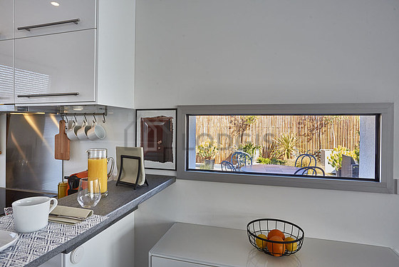 Kitchen equipped with dishwasher, refrigerator, extractor hood, crockery