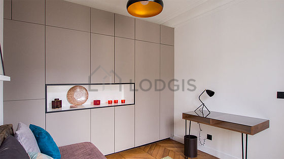 Bright bedroom equipped with desk, wardrobe, cupboard