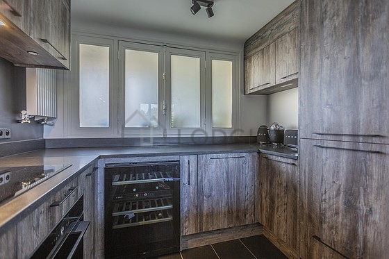 Kitchen equipped with crockery, stool