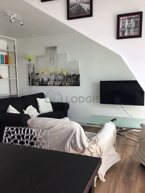 Very quiet living room furnished with tv, 1 armchair(s), 1 chair(s)