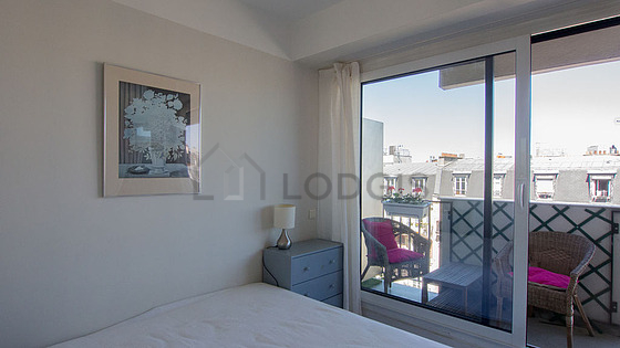 Bedroom with windows and balcony