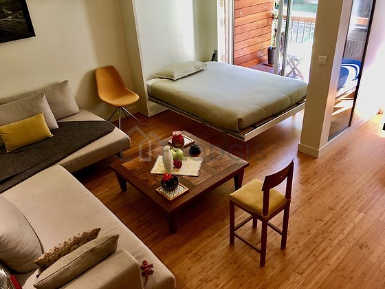 Living room with windows and balcony facing the garden