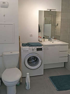 Bathroom equipped with washing machine, cupboard