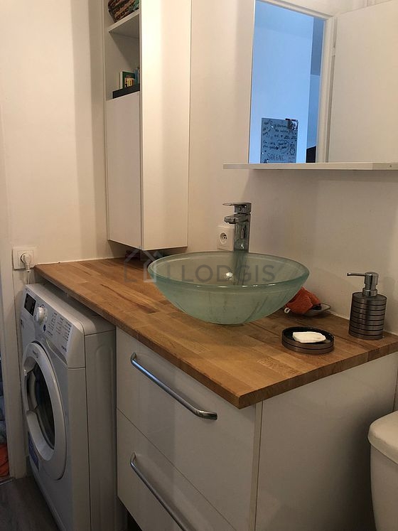 Bathroom equipped with washing machine, bath towels