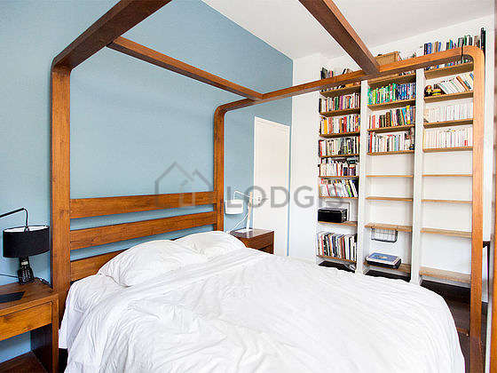 Bright bedroom equipped with 1 armchair(s), bedside table
