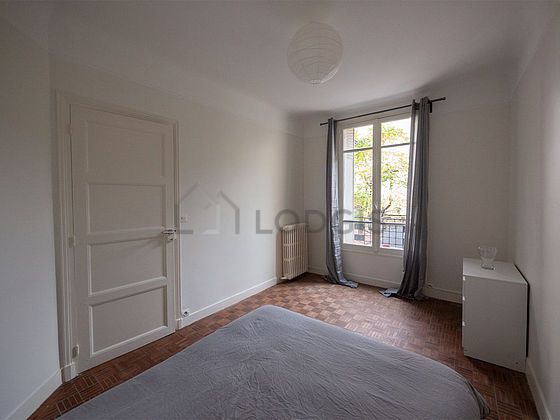 Bright bedroom equipped with storage space, bedside table
