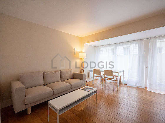 Very quiet living room furnished with 1 bed(s) of 140cm, sofa, coffee table, storage space