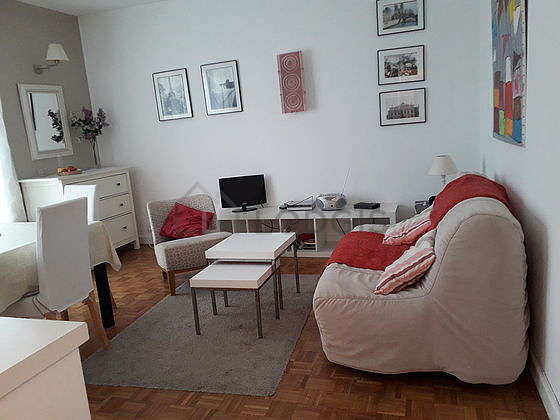 Very quiet living room furnished with tv, dvd player, 1 armchair(s), 1 chair(s)