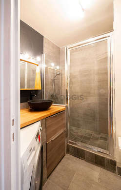 Bathroom equipped with washing machine, separate shower, hair-dryer