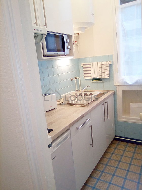 Kitchen equipped with hob, refrigerator, freezer, extractor hood