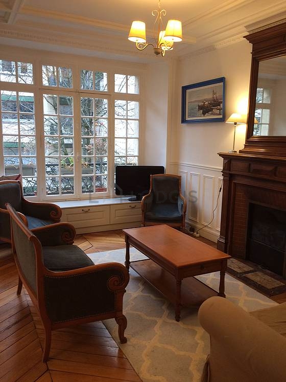 Very quiet living room furnished with tv, 1 armchair(s)