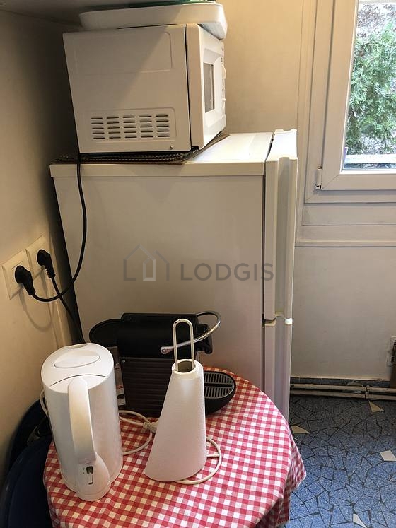 Kitchen equipped with washing machine, refrigerator, extractor hood, crockery