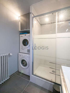 Bathroom equipped with washing machine, dryer, cupboard