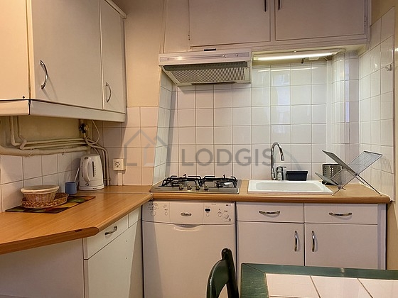 Kitchen equipped with dishwasher, hob, refrigerator, crockery