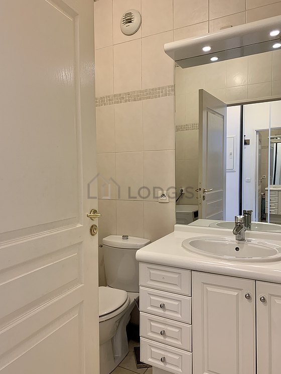 Bathroom equipped with washing machine, cupboard