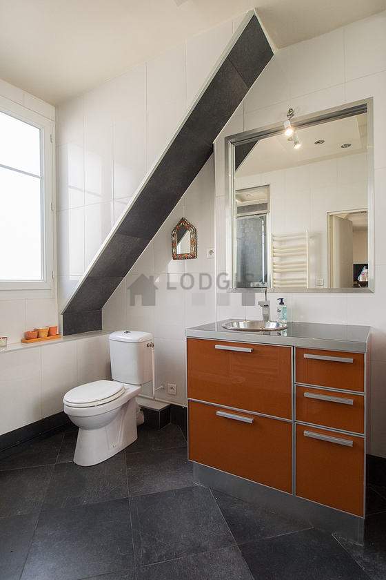 Bright bathroom with windows and with tile floor