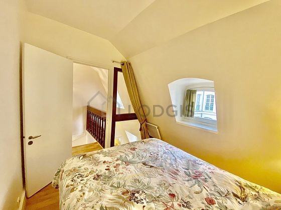 Bright bedroom equipped with bedside table