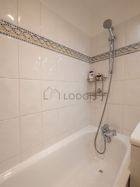 Bathroom equipped with washing machine, cupboard