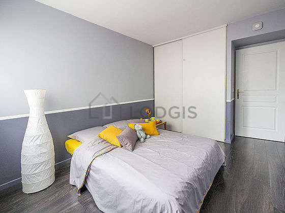 Very bright bedroom equipped with wardrobe, bedside table