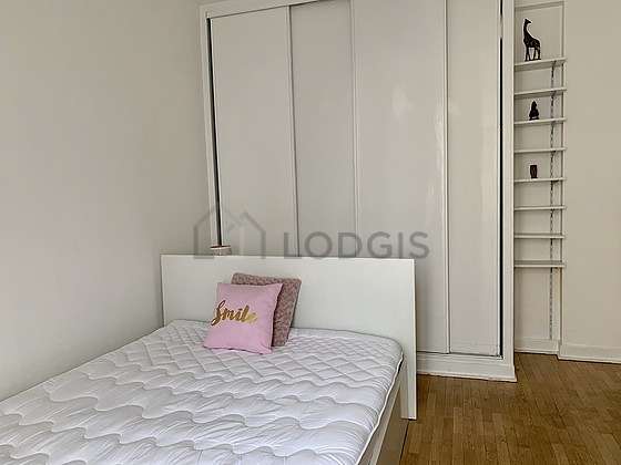 Very bright bedroom equipped with closet, cupboard, bedside table