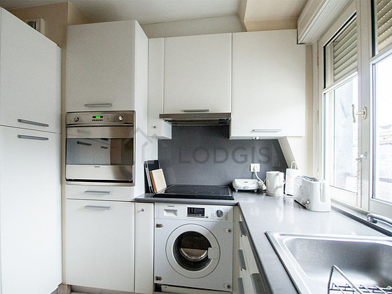 Kitchen where you can have dinner for 2 person(s) equipped with washing machine, refrigerator, extractor hood, crockery