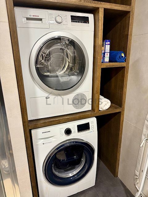 Bathroom equipped with washing machine, dryer, bath towels