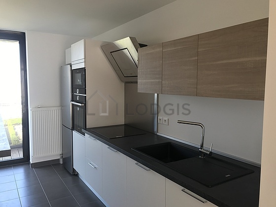Kitchen equipped with washing machine, dryer, refrigerator, extractor hood