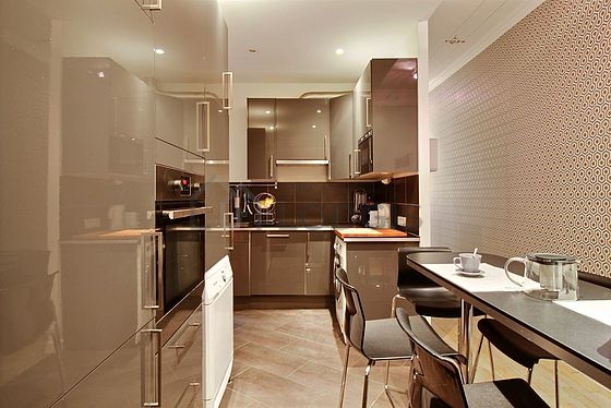 Kitchen equipped with washing machine, dryer, refrigerator, crockery