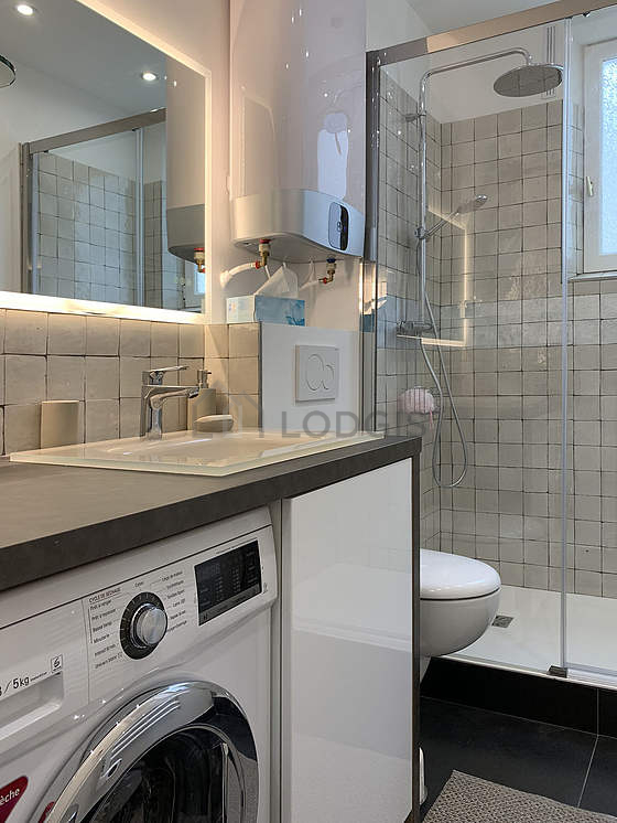Bathroom equipped with washing machine, shelves