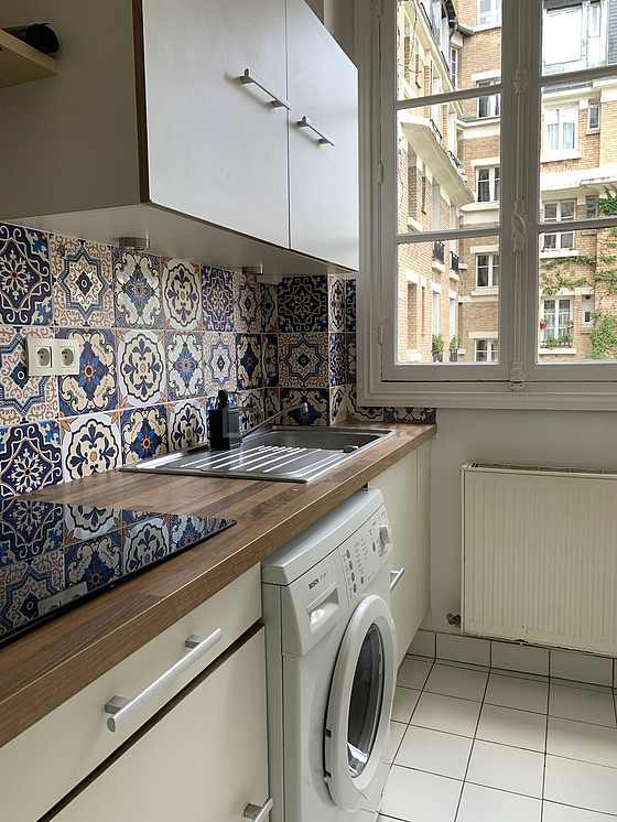 Kitchen equipped with washing machine, dryer, refrigerator, crockery