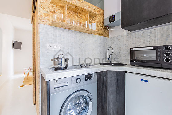 Kitchen equipped with washing machine, refrigerator, freezer, crockery