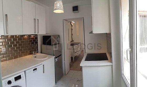 Kitchen equipped with washing machine, refrigerator, freezer, crockery