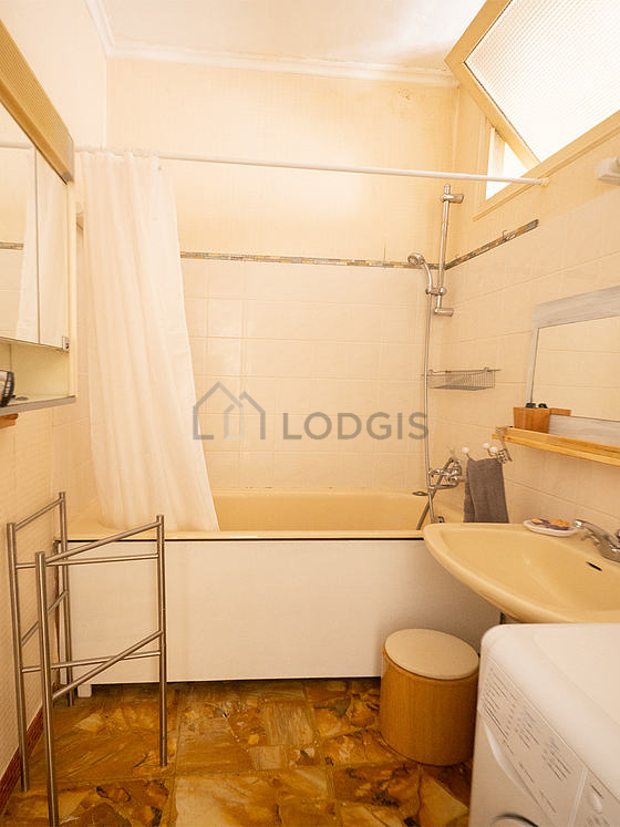 Salle de bain équipée de lave linge, baignoire, sèche cheveux