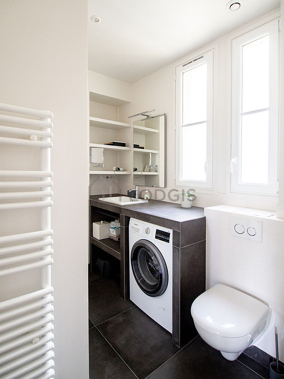 Beautiful and bright bathroom with double-glazed windows and with tile floor