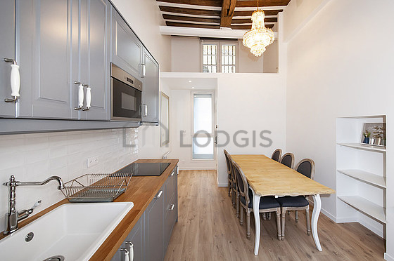 Kitchen equipped with dishwasher, hob, refrigerator, extractor hood