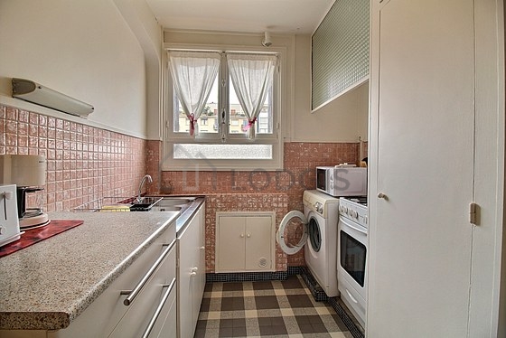 Kitchen equipped with washing machine, refrigerator, crockery