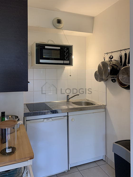 Cuisine équipée de plaques de cuisson, réfrigerateur, vaisselle