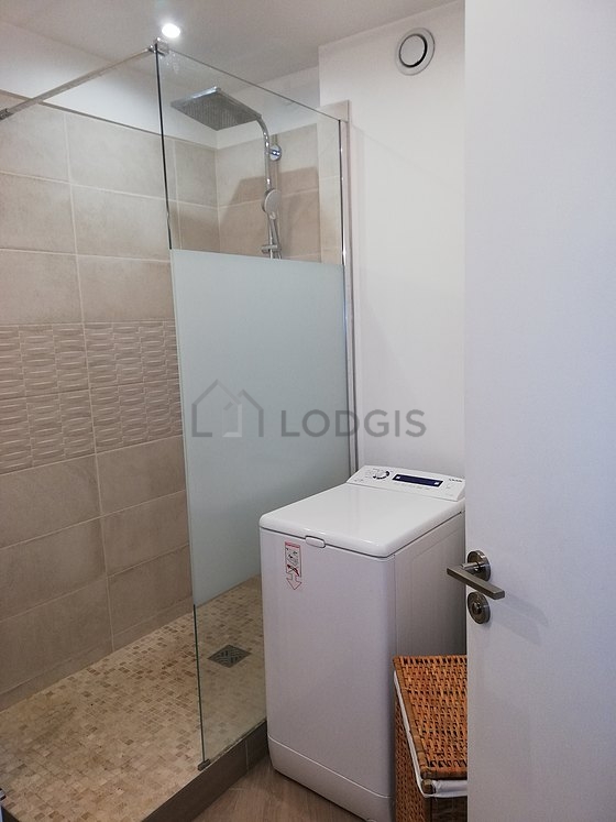 Bathroom equipped with washing machine, bath towels