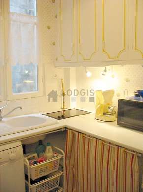 Kitchen equipped with washing machine, refrigerator, crockery