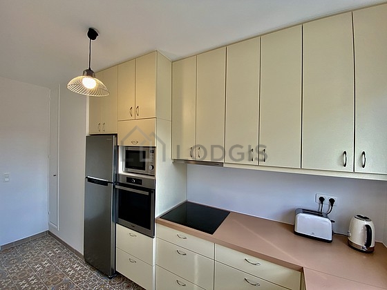 Kitchen equipped with crockery, stool