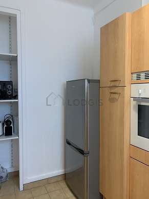 Kitchen equipped with washing machine, refrigerator, crockery, stool