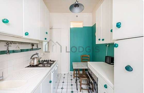 Kitchen where you can have dinner for 2 person(s) equipped with washing machine, refrigerator, extractor hood, crockery