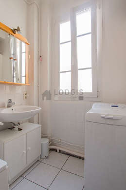 Belle salle de bain avec fenêtres et du carrelageau sol
