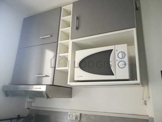 Kitchen equipped with crockery, stool