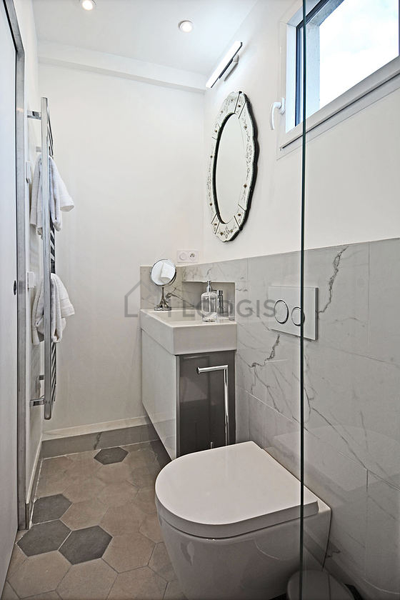 Bathroom equipped with washing machine, dryer, bath towels