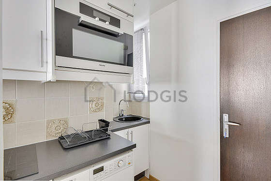 Kitchen equipped with washing machine, dryer, refrigerator, crockery
